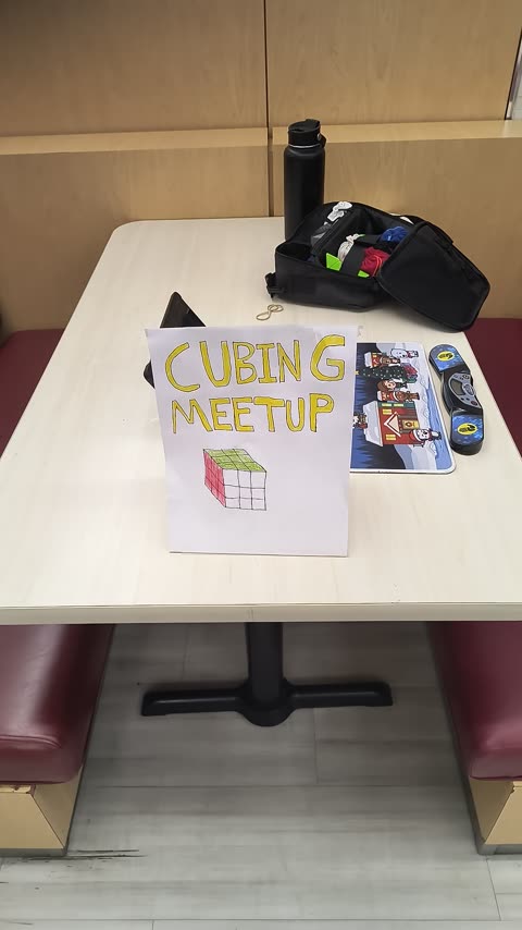 Cubing meetup table with sign and equipment